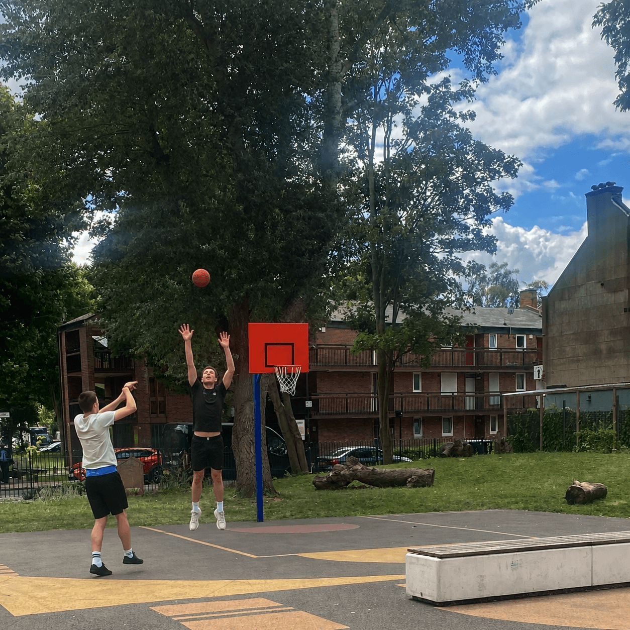 A player shooting a hoop over a defender